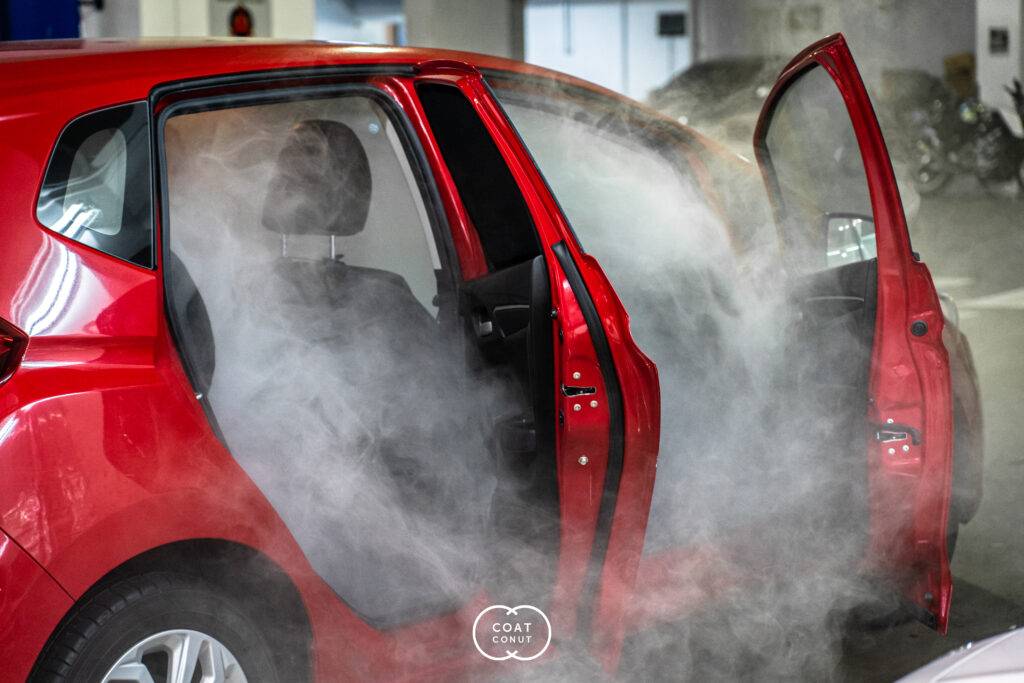 Interior steam cleaning in progress on a car seat