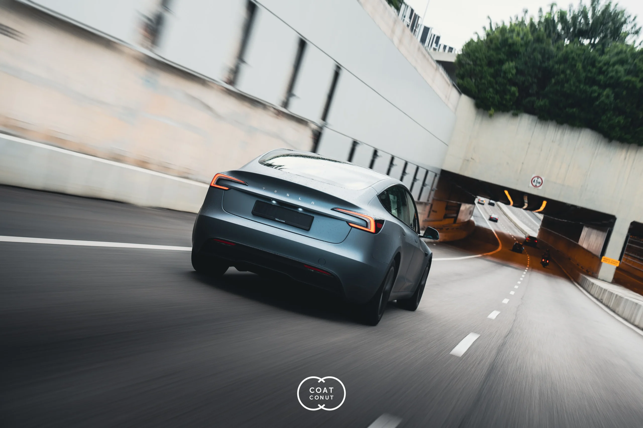Grey Tesla rolling shot on a Singapore road, photographed for Coatconut